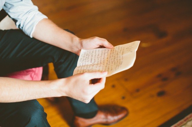 16 Groom reading note from bride before wedding ceremony